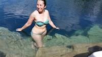 A visitor from New York takes a cool dip in the crystal clear waters at The Coffey Grounds