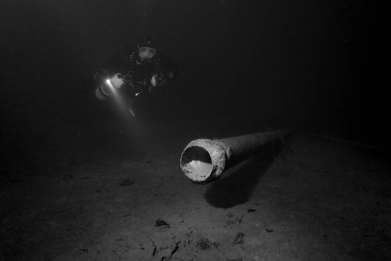 scuba diver and pipe