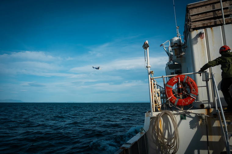 ship at sea and helicopter