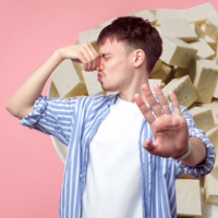 person holding nose and tofu