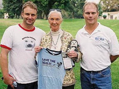 Jane Goodall holding save the seals shirt